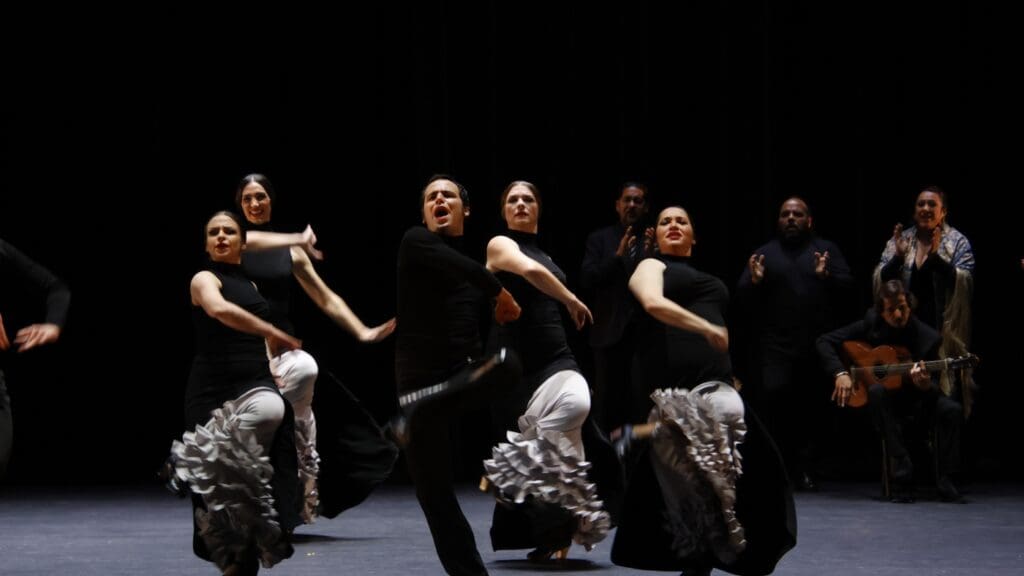Flamenco dancers performing on stage.