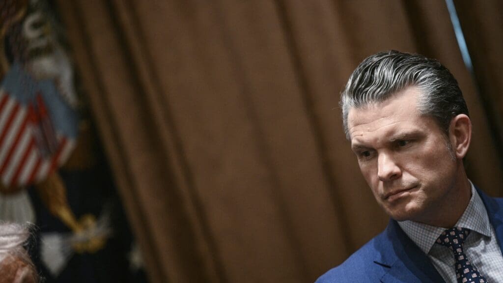 Man in suit with serious expression.