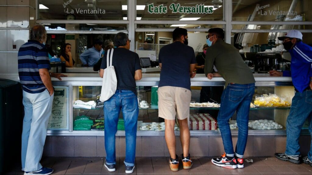 Cuban-Americans in Miami elevate problems concerning expulsions: NPR People ordering at a cafe window counter.