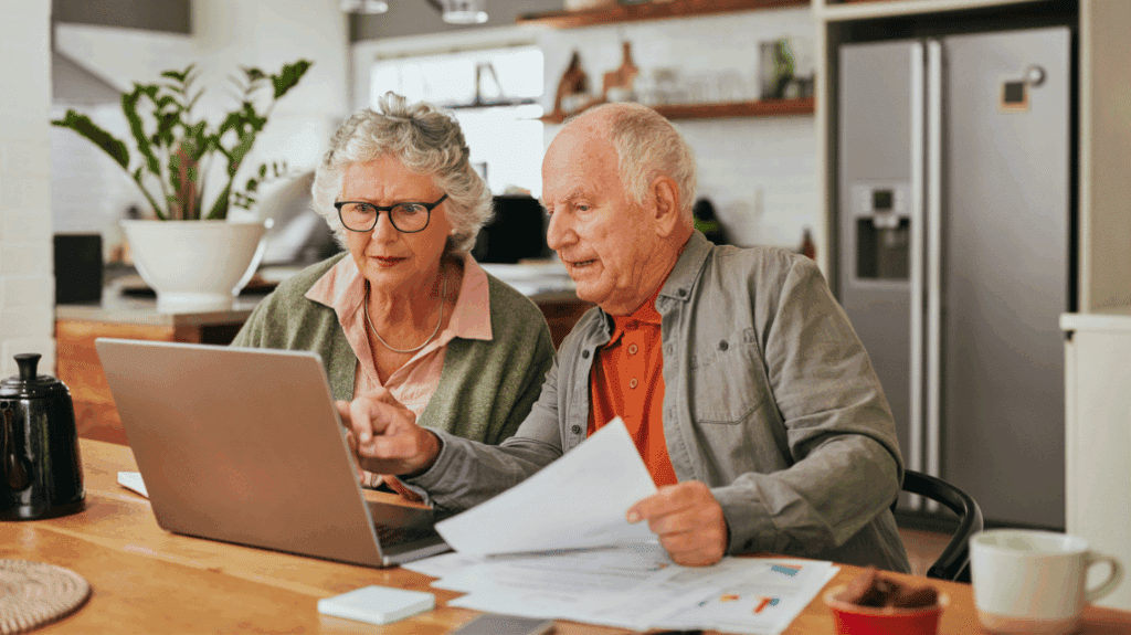 Senior couple reviewing finances on a laptop