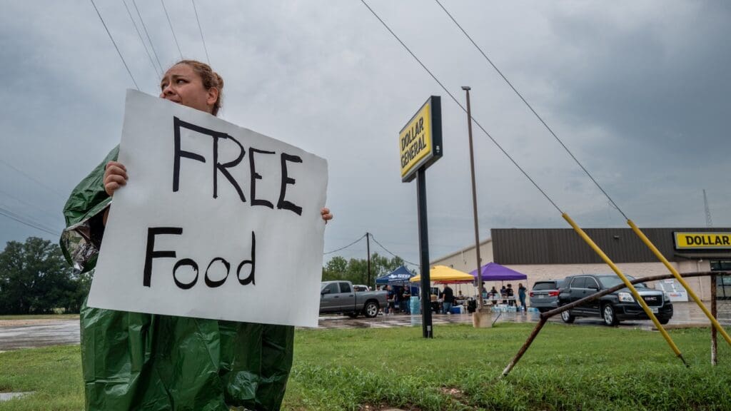 Texas food financial institutions are allocating dishes for flooding survivors as a result of Trump’s cuts A volunteer displays a sign for free food for people in need of relief on July 06, 2025 in Center Point, Texas.