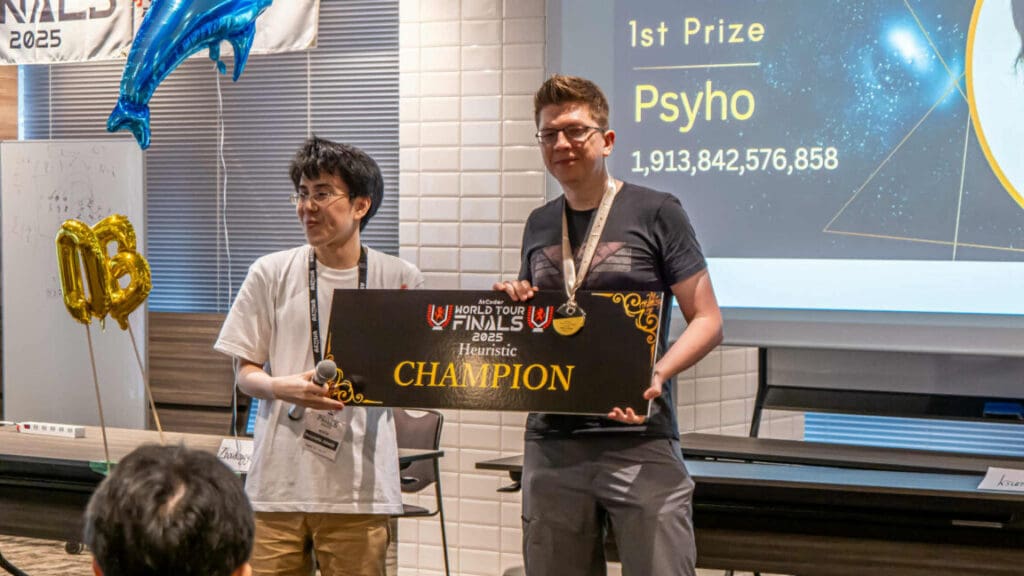 Exhausted man defeats AI model in world coding championship Przemysław Dębiak (right) receives an award for winning the 2025 AtCoder World Finals Heuristic Contest.
