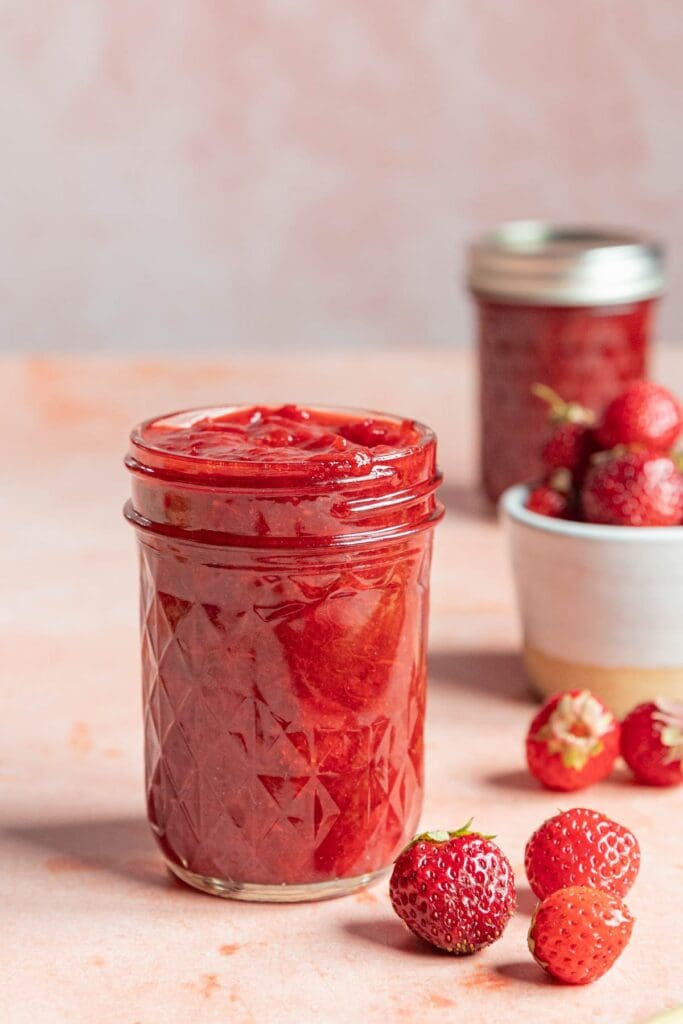 5-Ingredient Strawberry Rhubarb Jam (No Pectin) Strawberry jam in jars with fresh strawberries.