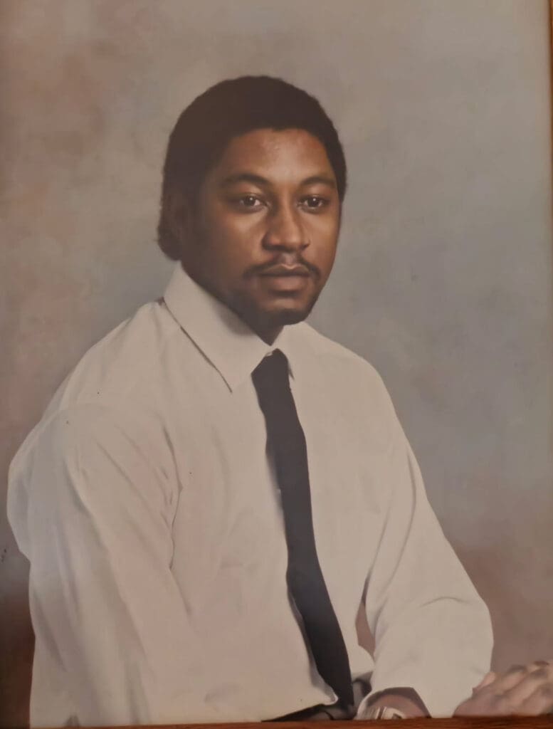 Man in white shirt and black tie.