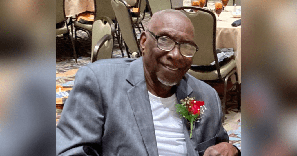 Smiling man in glasses wearing a suit.