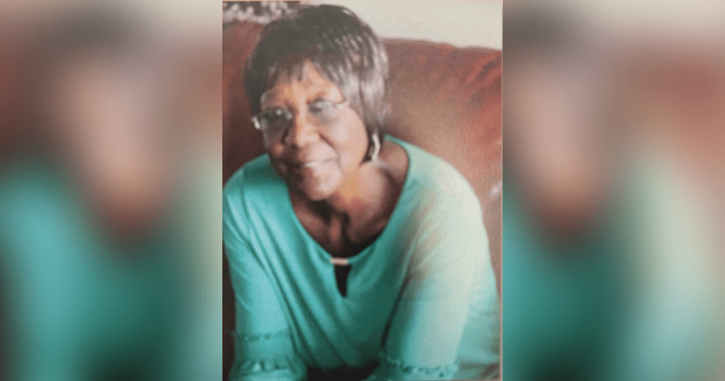 Smiling woman sitting on a red couch.