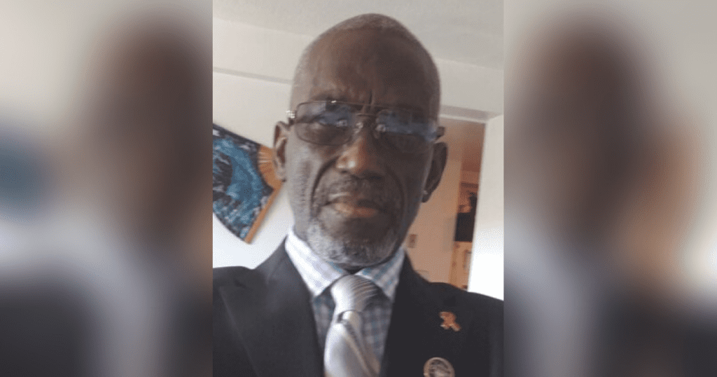 Man in suit with glasses and tie.