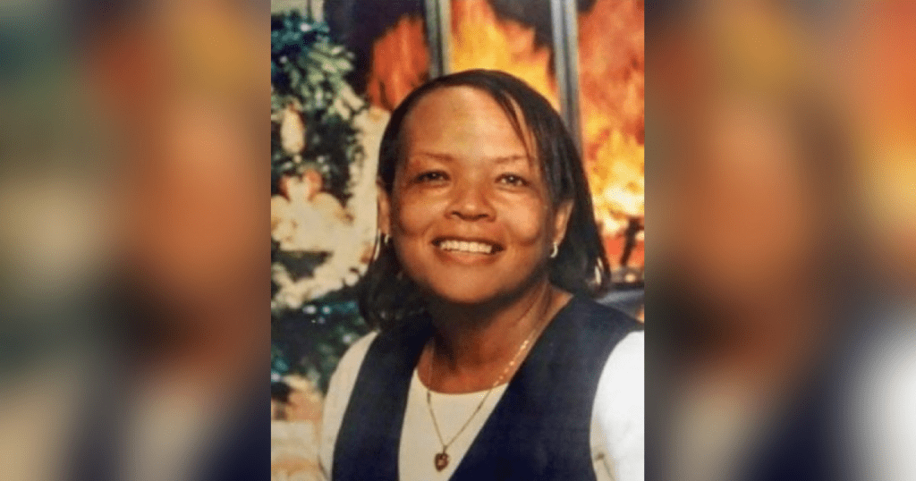 Smiling person in front of vibrant background.