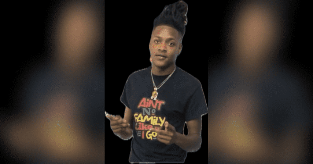 Person pointing in a black graphic t-shirt.