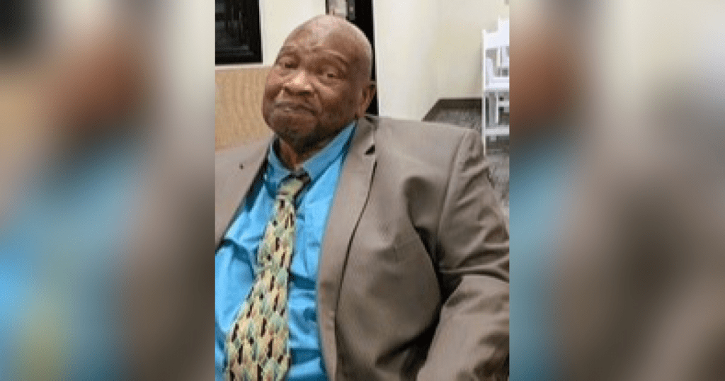 Man wearing suit and patterned tie.