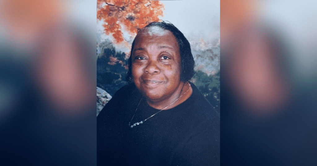 Smiling woman with autumn foliage background.
