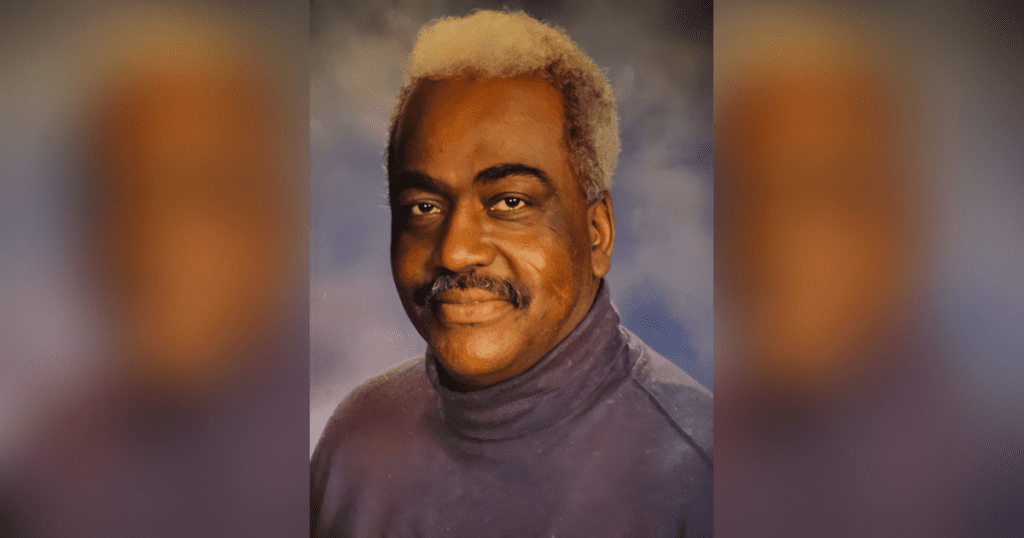 Portrait of a smiling man in turtleneck.