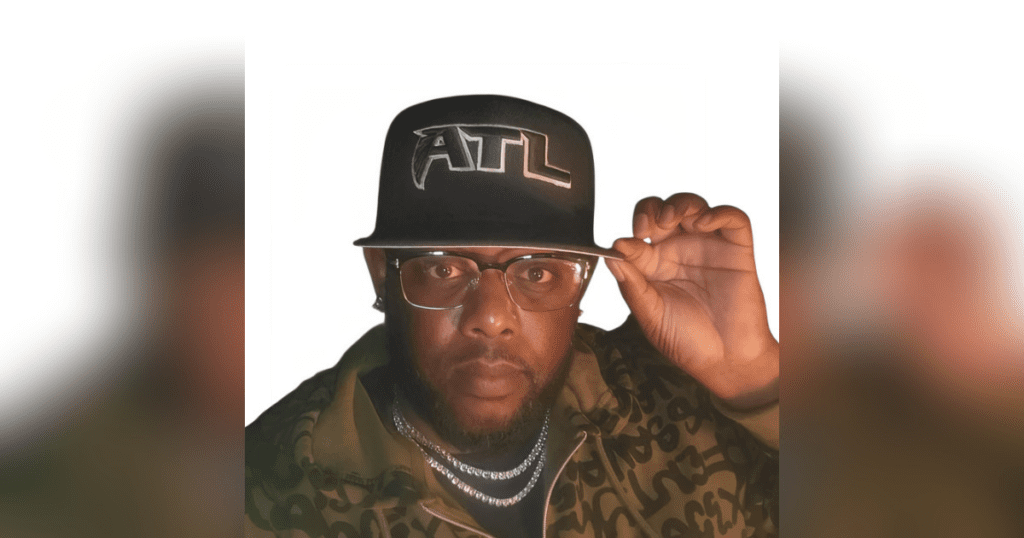 Man wearing glasses and ATL cap.