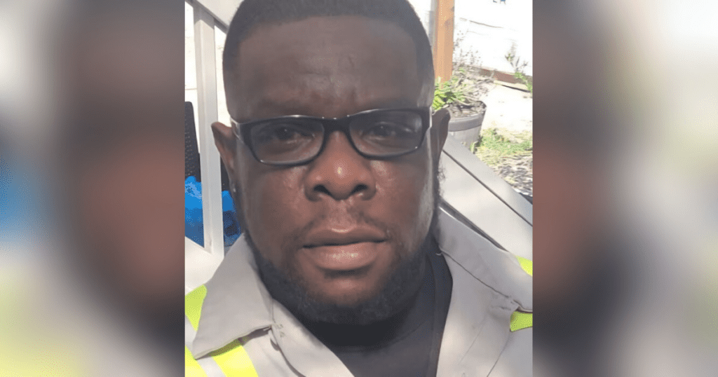 Man wearing glasses and high-visibility jacket.