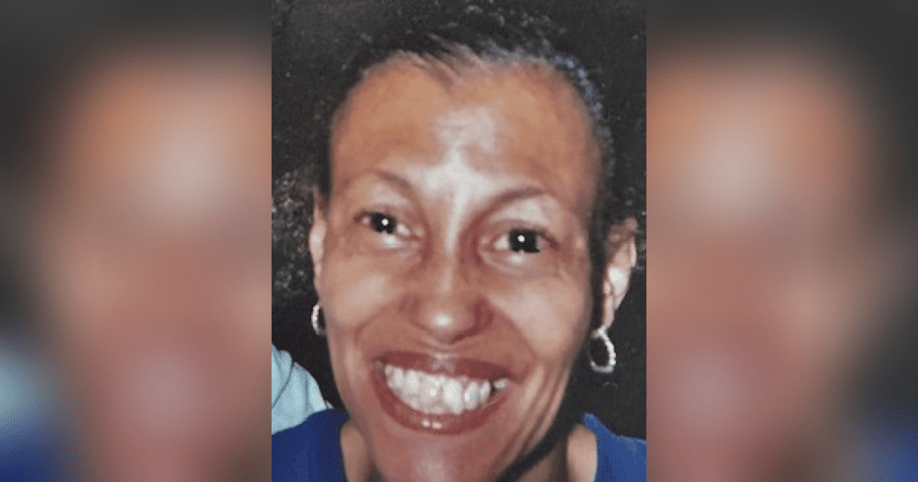 Smiling person with hoop earrings.