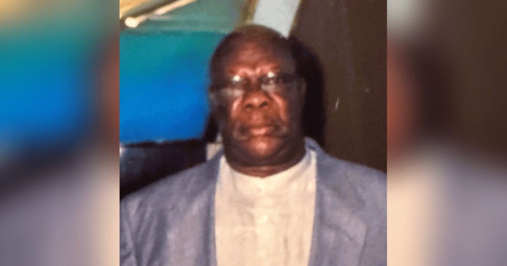 Man in suit with blurred background.