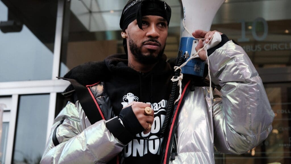 Person holding a megaphone outside a building.