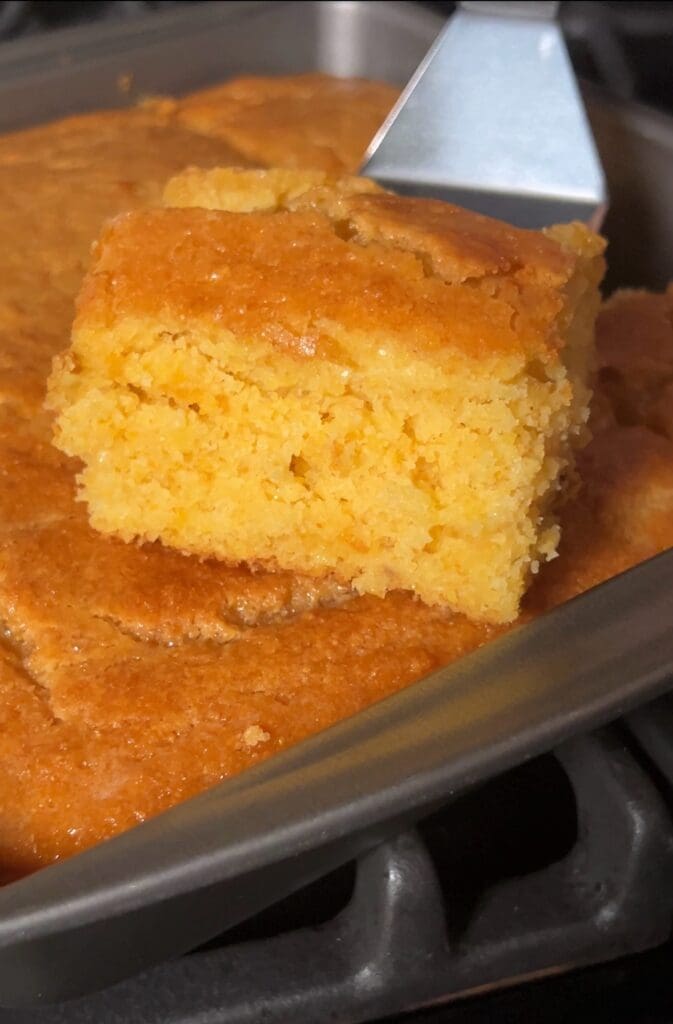 Freshly baked cornbread in a pan.