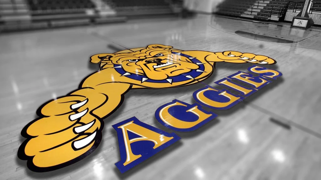 Aggies bulldog logo on basketball court floor.