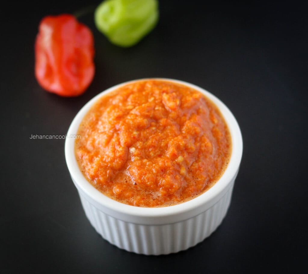 Spicy pepper sauce in white ramekin.