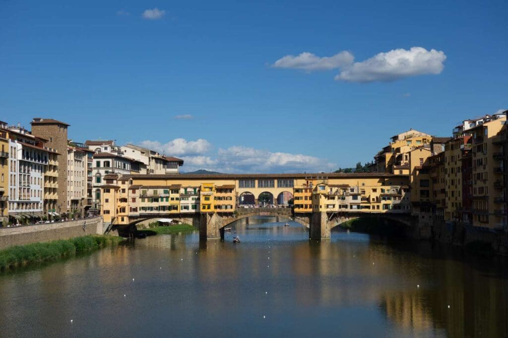 The Ponte Vecchio bridge in Florence Italy spanning the Arno River surrounded by historic buildings