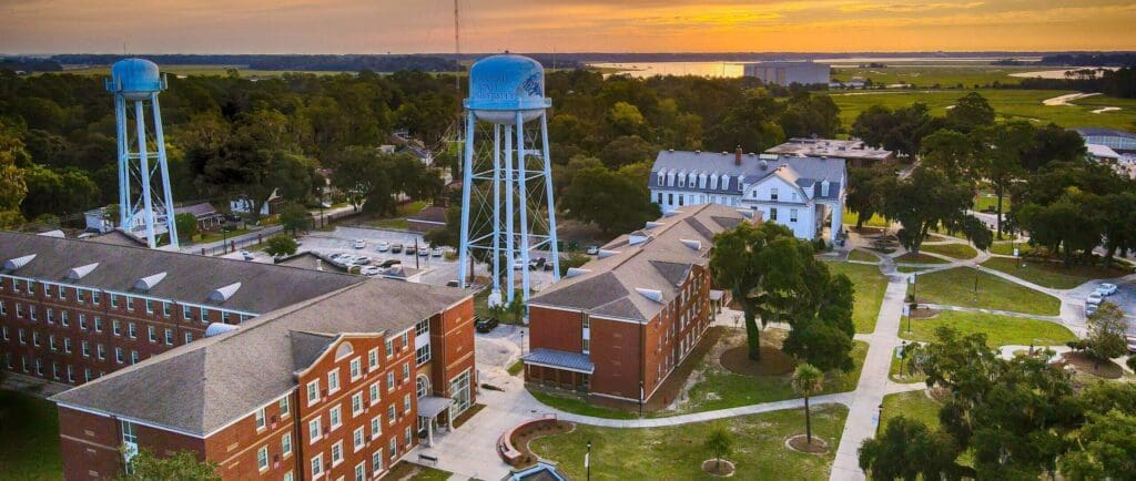 Campus buildings and water towers at sunset.