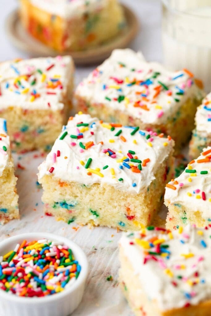 slice of funfetti sheet cake on parchment paper