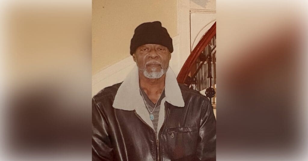 Man wearing black beanie and leather jacket.