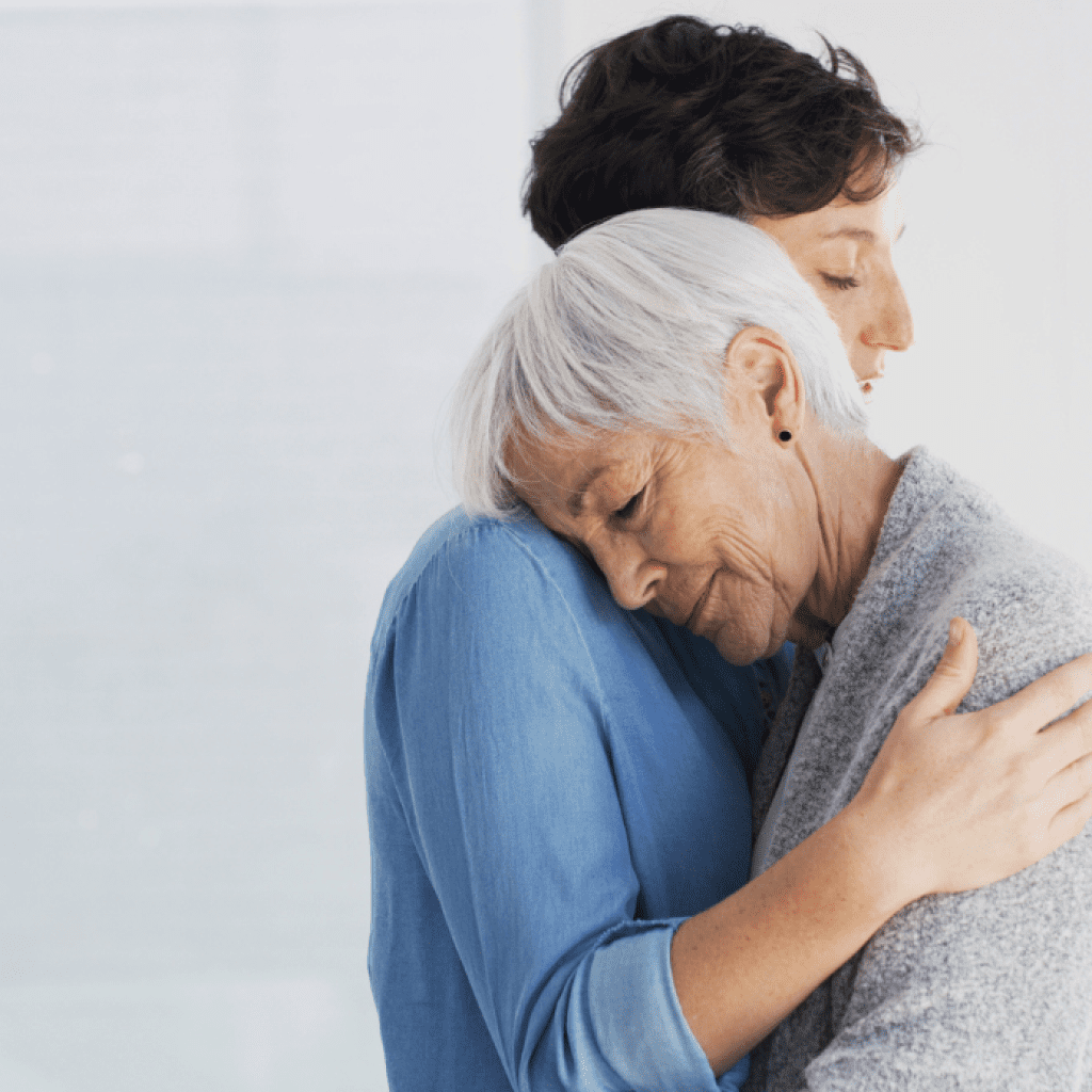 Adult woman hugging her senior mom