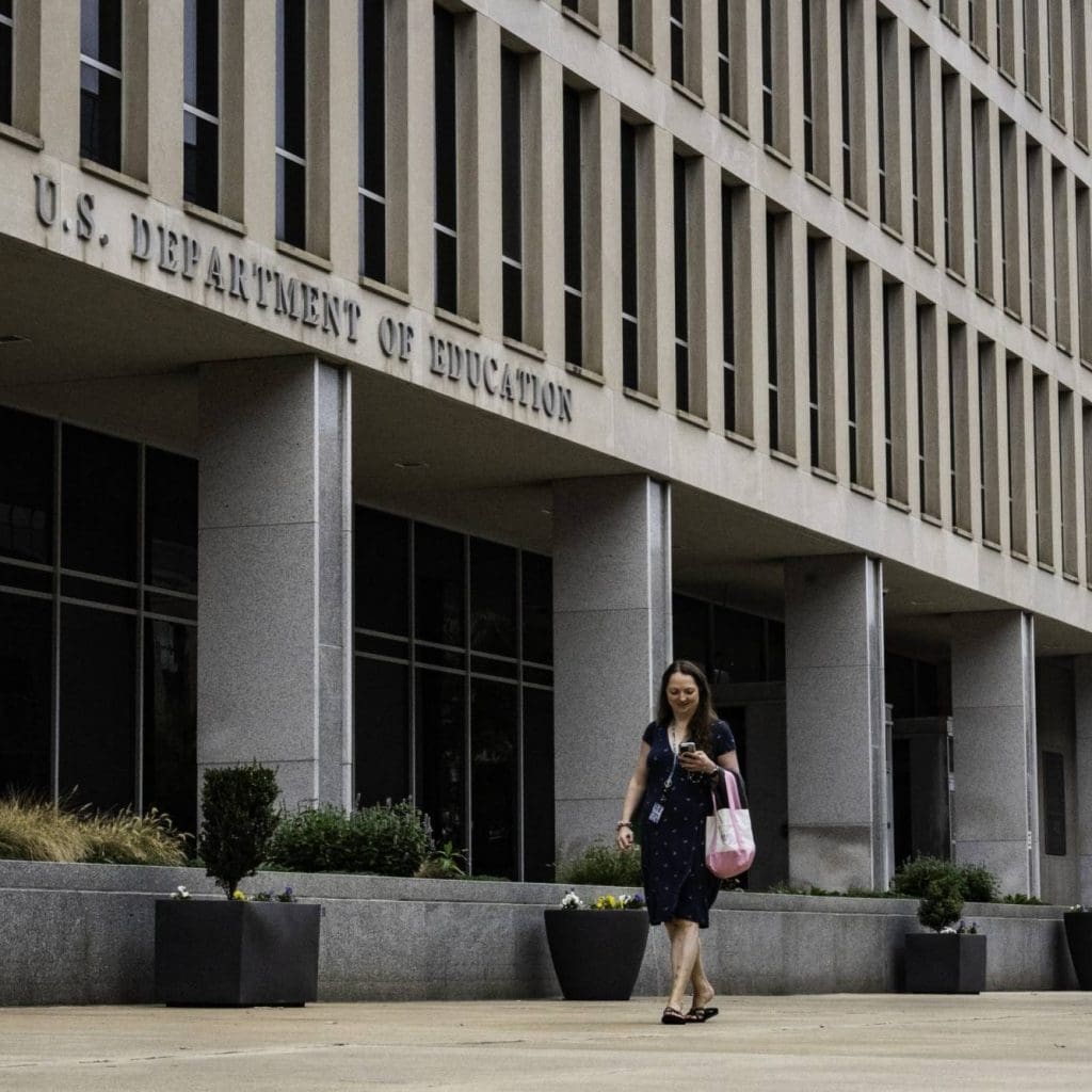 Woman walking past federal building