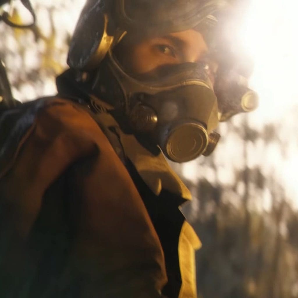 Arc Raiders raider in a pilot helmet looks at the camera in a sunlit forest