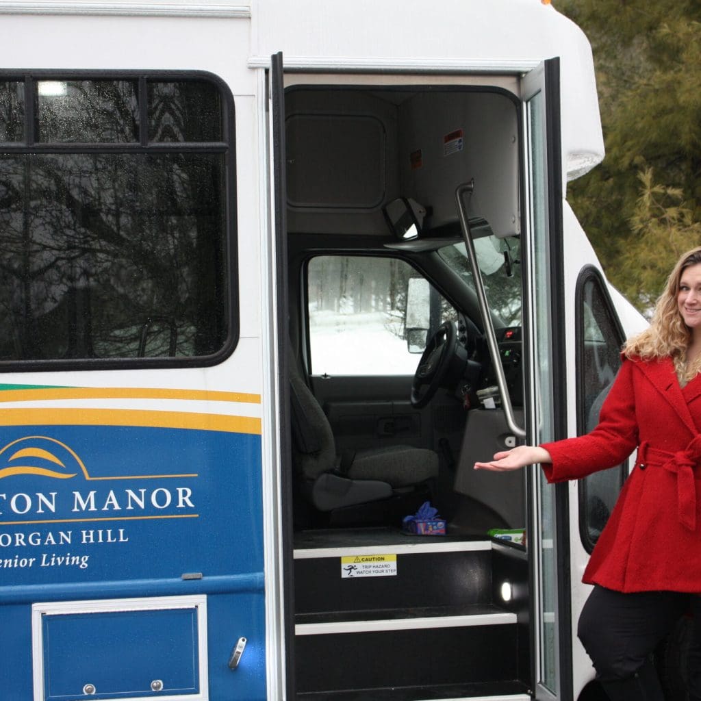 Natasha Foster, LifeStages Director, standing beside the new Abington Manor at Morgan Hill senior living community bus in Easton, PA.