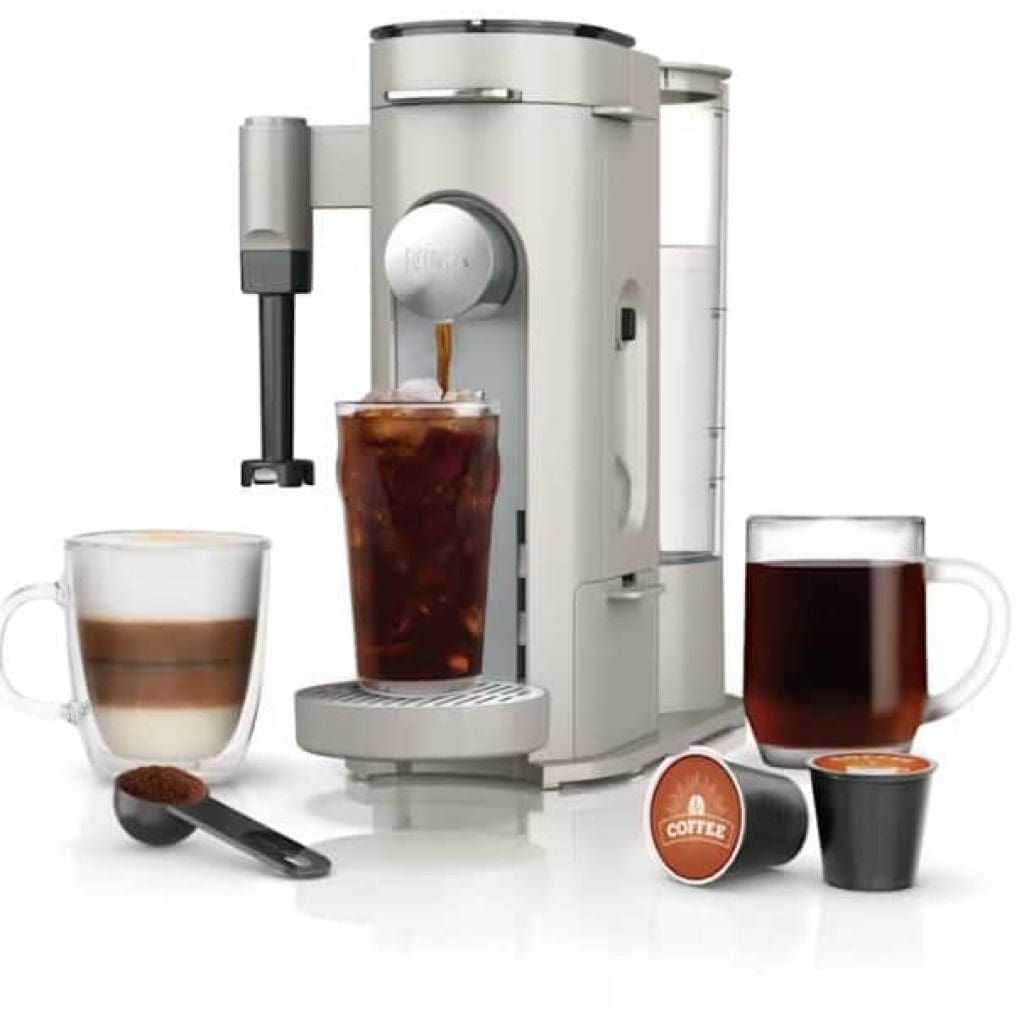 A modern coffee machine with two coffee cups and a coffee capsule.