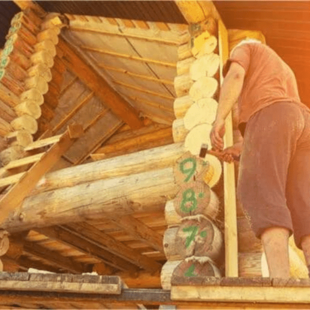 A man building a log house himself as part of a build your own house program