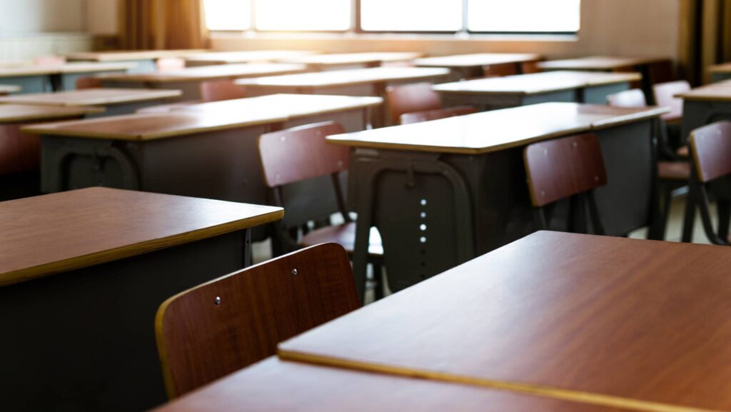 They’re Urged to Speak Out, But Education Researchers Face a High-stakes Choice Empty desks in a classroom