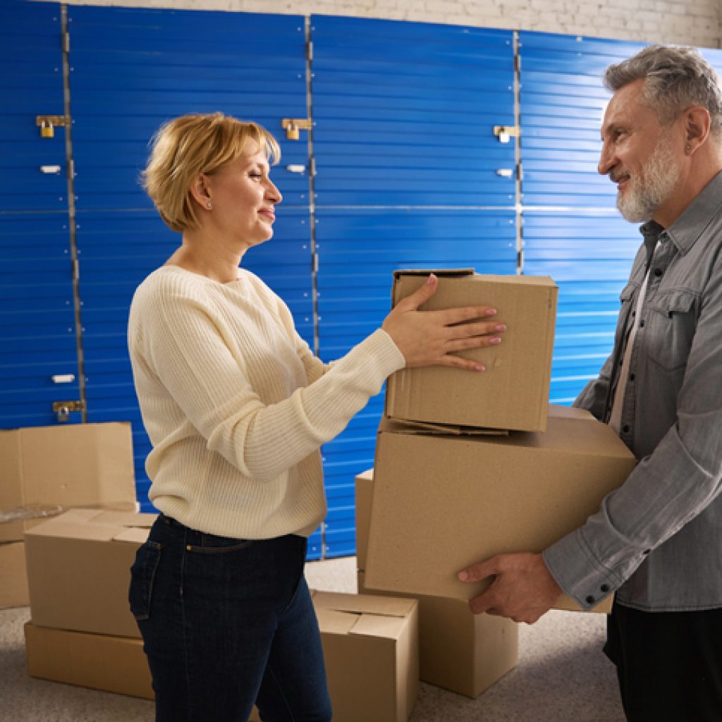 An older adult couple places items in storage before downsizing