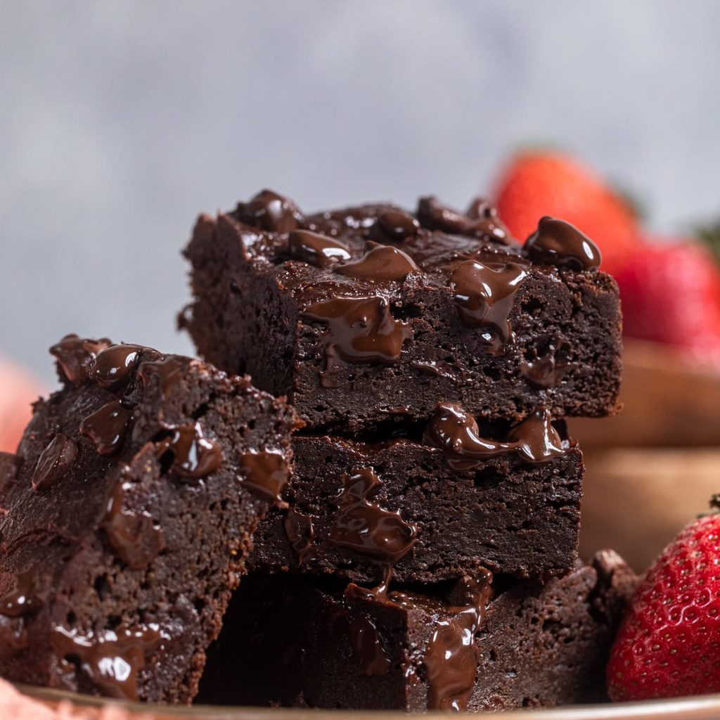 a stack of three sweet potato brownies on a plate.
