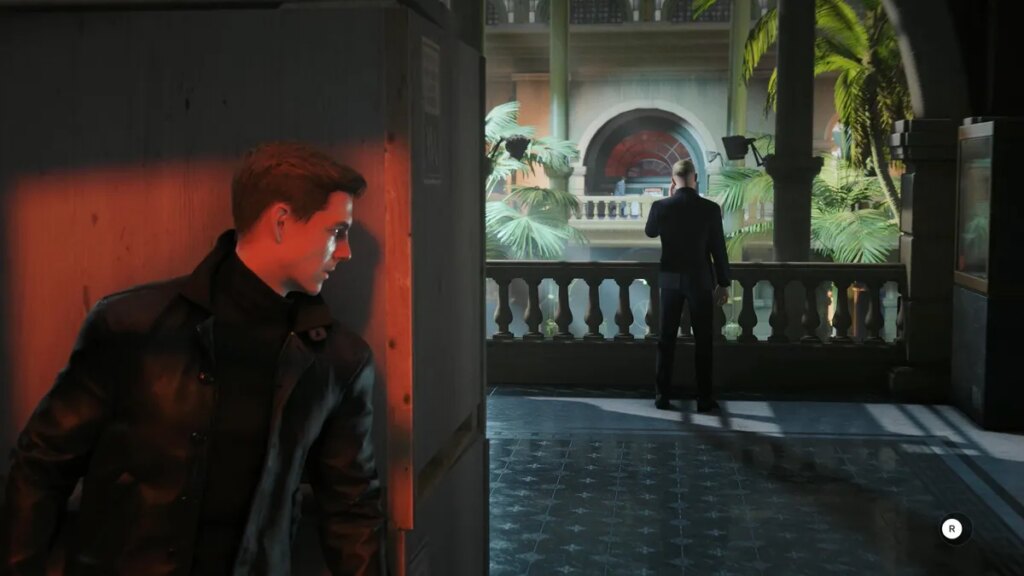 An in-game screenshot of a man hiding behind a corner before ambushing another man on the phone.