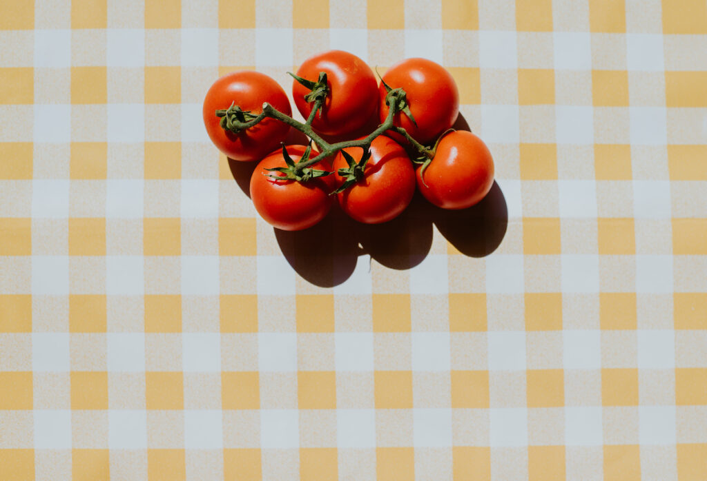 Tomatoes on a tablecloth (Catherine Falls Commercial/ Getty Images )