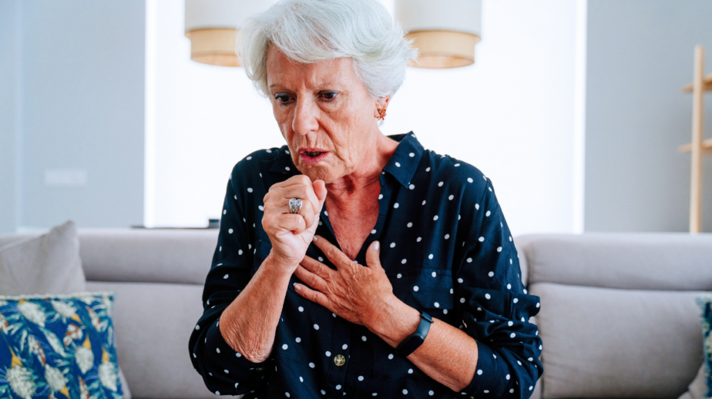 Aspiration Pneumonia Diet: Foods Seniors Should Eat Senior woman coughing while sitting on couch