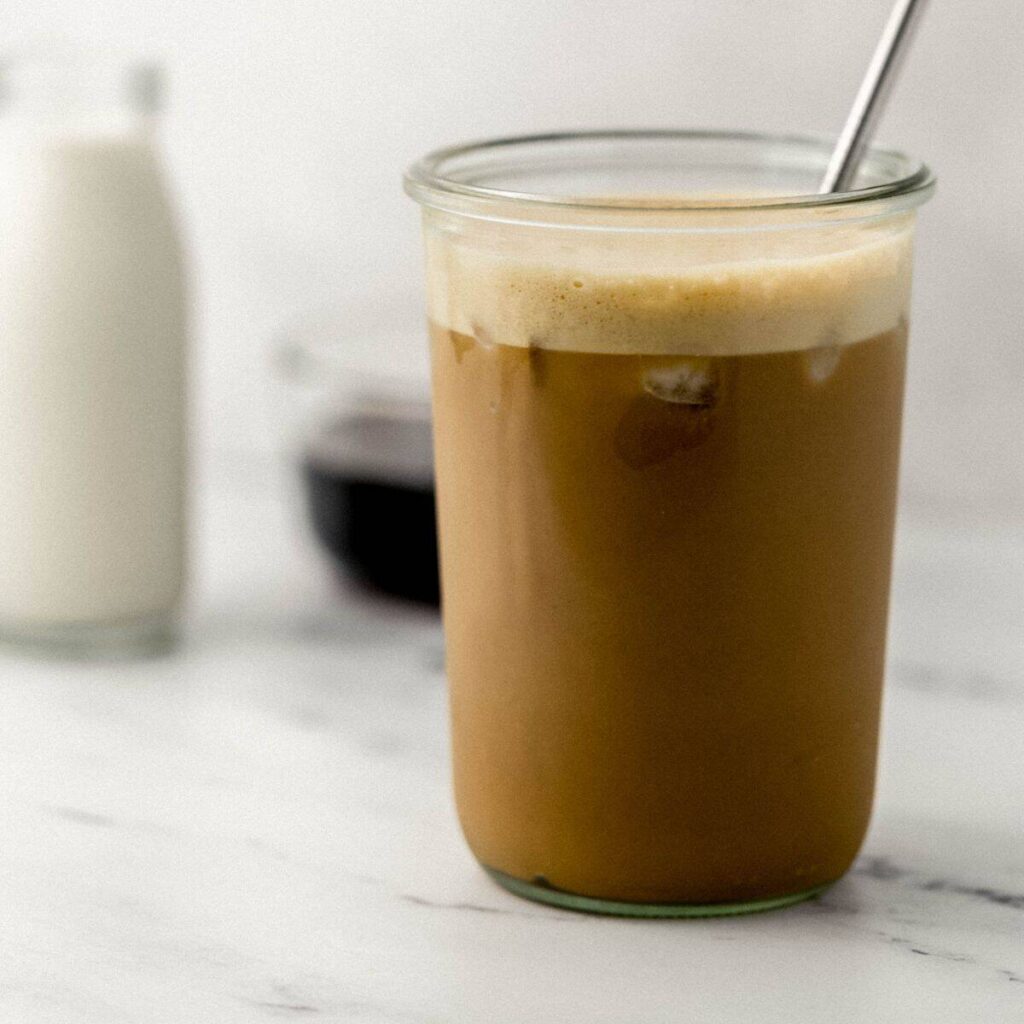 Iced Brown Sugar Oat Milk Shaken Espresso Recipe Two finished photos of espresso on pin with text overlay.