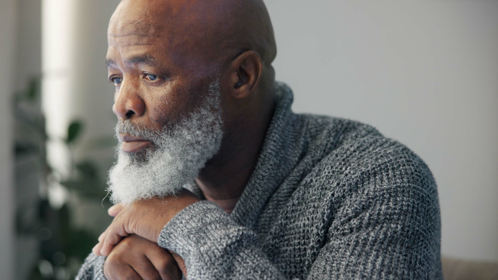 Supporting Seniors After the Loss of a Spouse or Longtime Partner elderly black man staring out the widow in grief