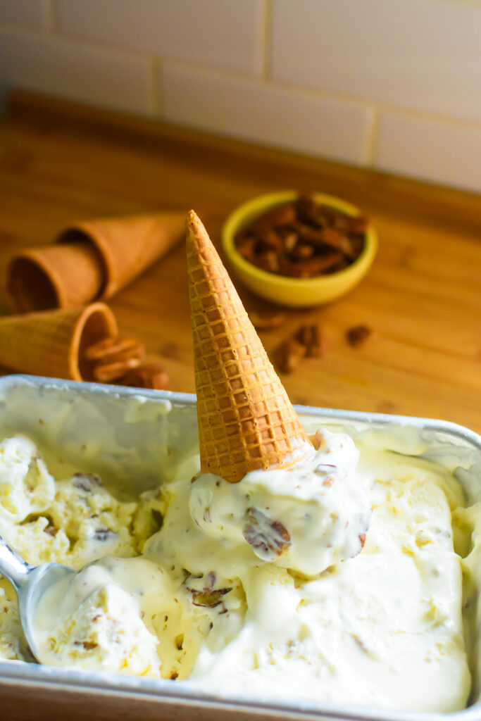 the best butter pecan ice cream made with condensed milk and a few other ingredients in an upside-down waffle cone.