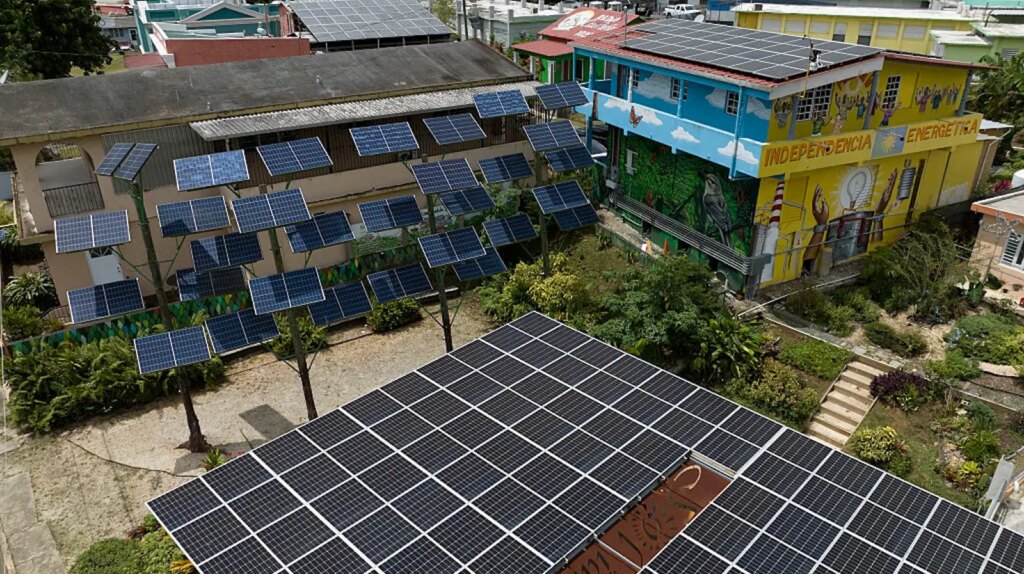 Inside the government’s push to divert Puerto Rico solar funds to a bankrupt utility Aerial view of multiple solar panels on rooftops