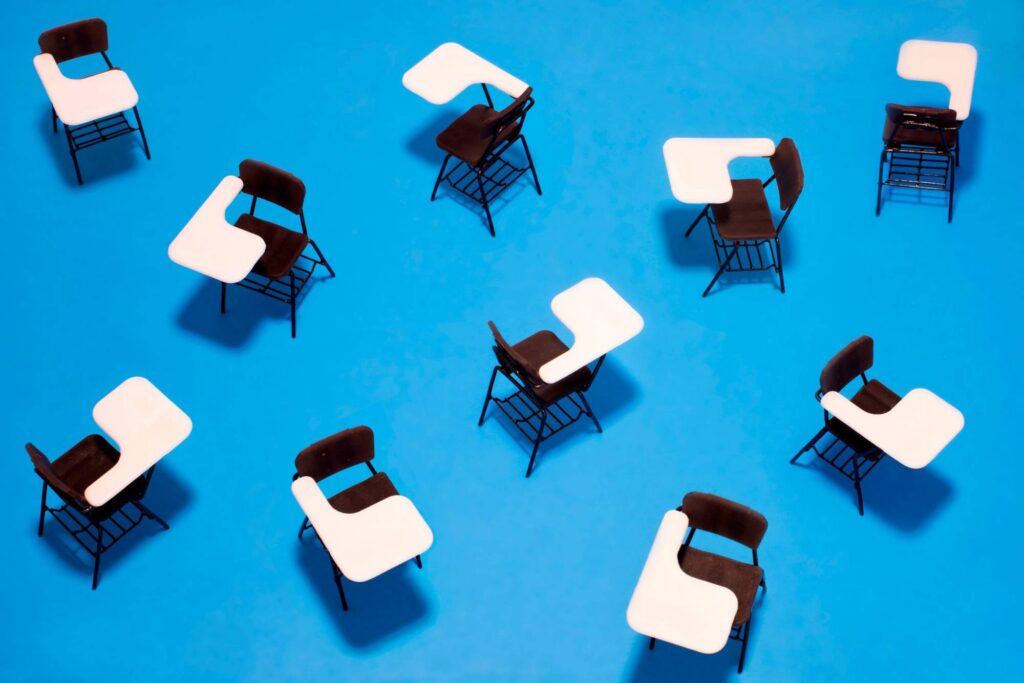 What Michigan Schools Reveal About Reversing Chronic Absenteeism Illustration of an overhead view of empty school desks