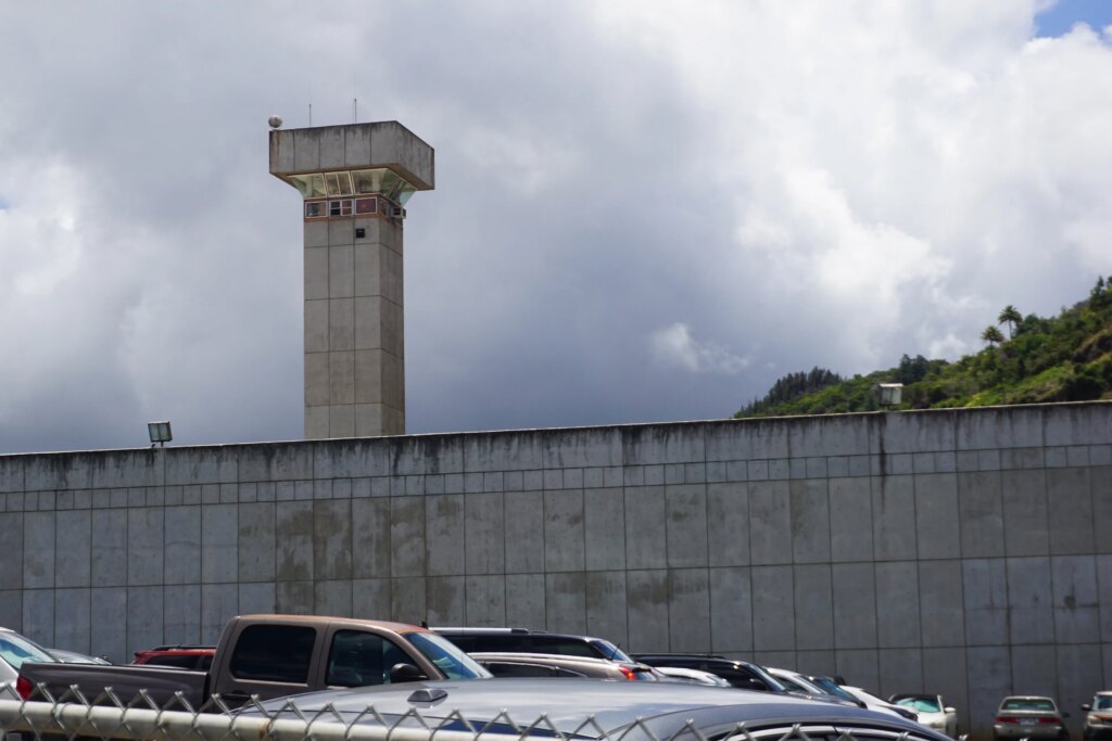 Severely Ill Prisoners Granted Early Release Are Left Stuck Behind Bars An exterior photo of Halawa Correctional Facility shows a guard tower.
