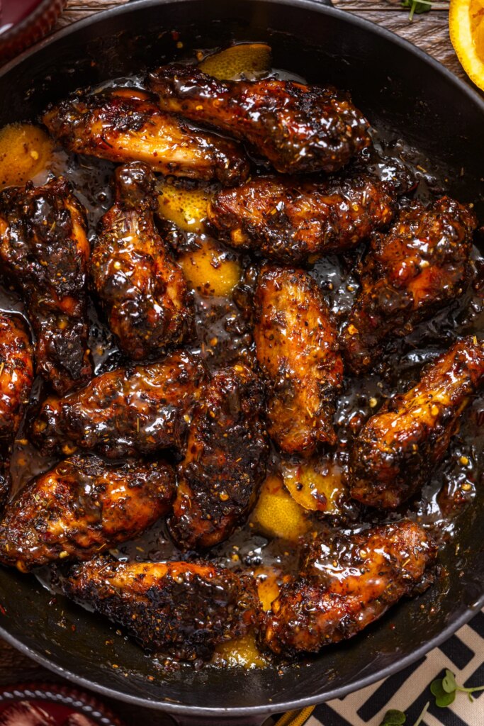 Up close shot of Sticky Orange Chicken Wings [Sweet + Spicy].