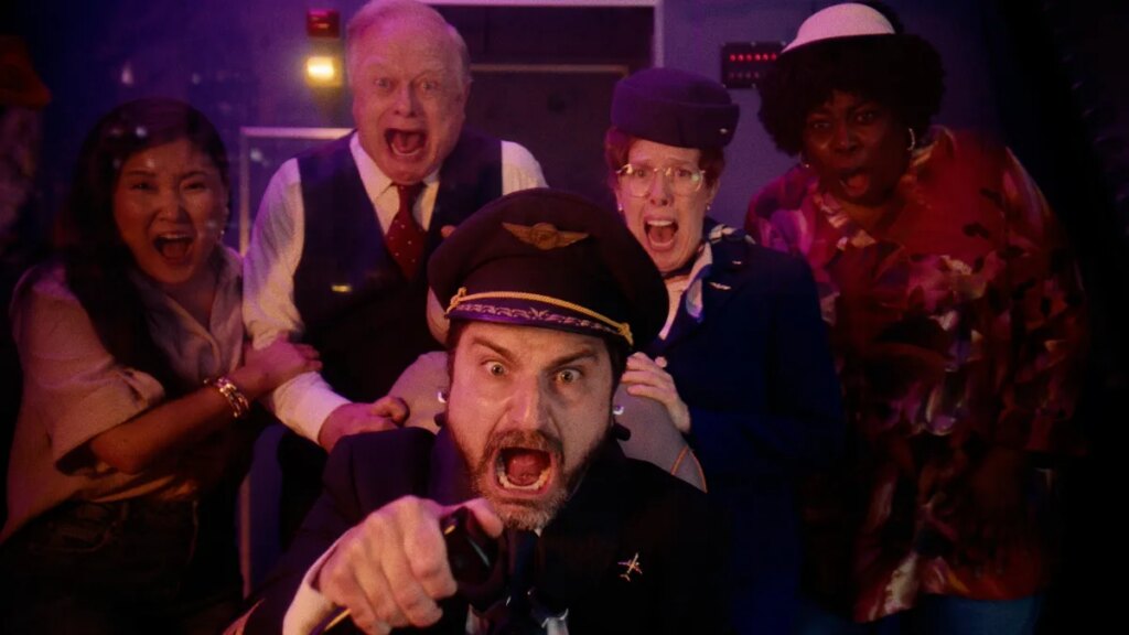Pilot and crew look terrified while pilot steers plane Roku City movie.