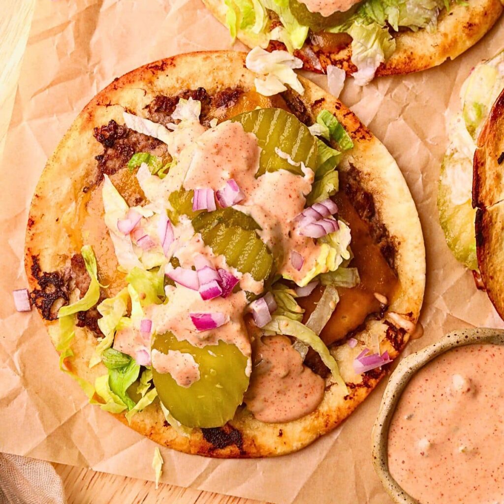 Smash Burger Tacos – Pink Owl Kitchen Smashburger tacos on a wooden cutting board.