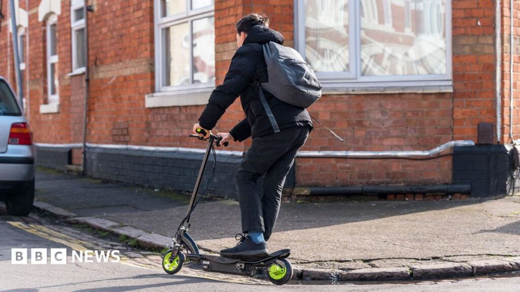 A boy riding an e-scooter on a residential street in the united Kingdom